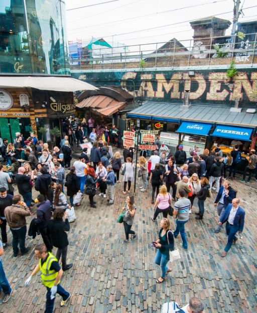 Crowds at Camden Market in London, with the famous Camden sign visible above the bustling market area