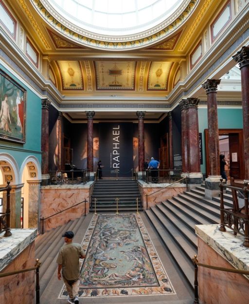 Interior of the National Gallery London showing the grand entrance hall with ornate columns and domed ceiling