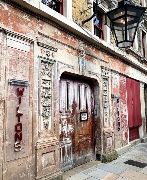 The weathered facade of Wilton's Music Hall on Graces Alley in Whitechapel, East London