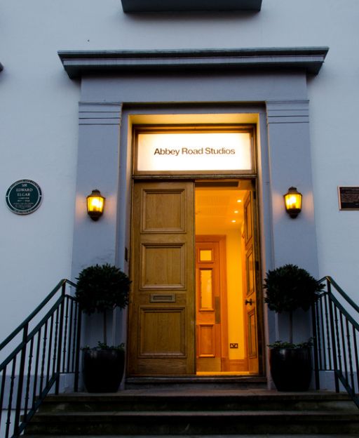 The famous entrance to Abbey Road Studios in St John's Wood, London, glowing warmly at dusk