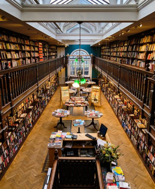 Inside Daunt Books on Marylebone High Street, London — a stunning Edwardian gallery bookshop with oak shelves and skylights