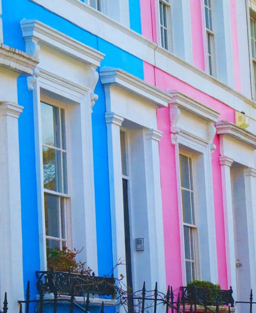 Colourful pastel-painted terraced houses on a quiet street in Notting Hill, London