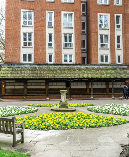 Postman's Park in the City of London, showing the garden and the covered cloister containing the Memorial to Heroic Self-Sacrifice
