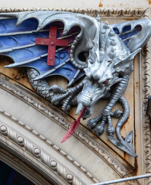 Dragon sculpture on the facade of Smithfield Market in the City of London, bearing the red cross of St George