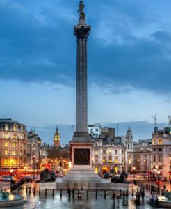Trafalgar Square at dusk with Nelson's Column and Big Ben in the background, London