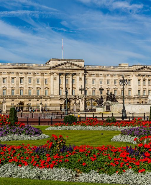 Buckingham Palace with Victoria Memorial and colourful flower beds in summer