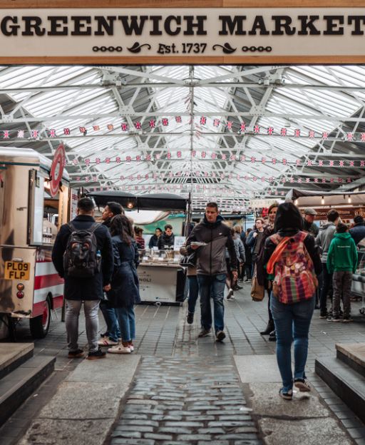 Visitors browsing stalls inside Greenwich Market, one of London's best food markets established in 1737