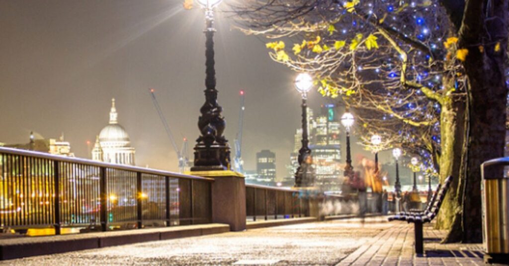 South Bank London riverfront walkway at night with St Pauls Cathedral in the background