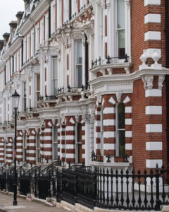 Victorian townhouses London UK - red brick terraced houses with iron railings