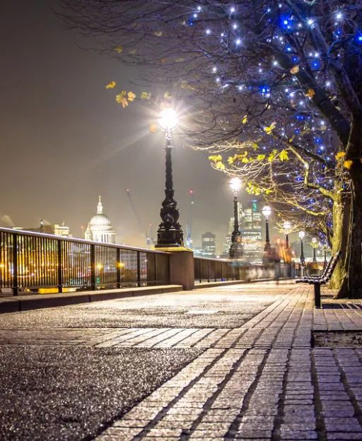 The Thames South Bank at night with fairy lights and St Paul's Cathedral in the background, London