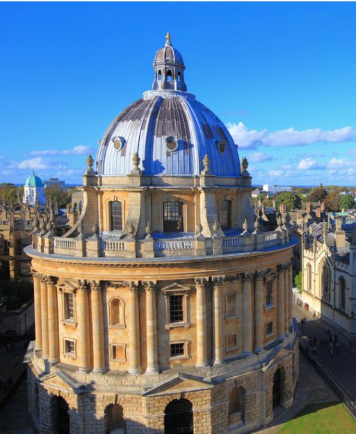 The Radcliffe Camera, Oxford's iconic domed circular library, against a bright blue sky