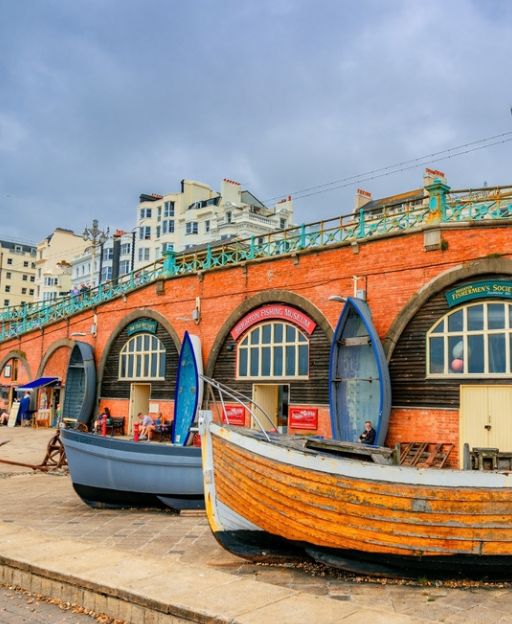 Brighton seafront fishing boats under distinctive arched brick buildings