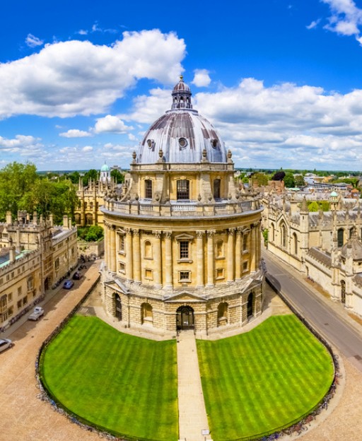 The Radcliffe Camera in Oxford, viewed from above against a blue summer sky