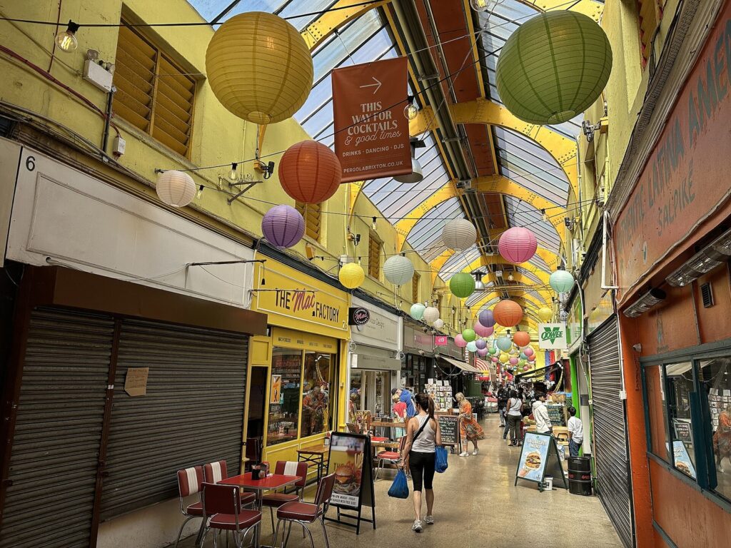 Paper lanterns above the covered arcade of Brixton Village market