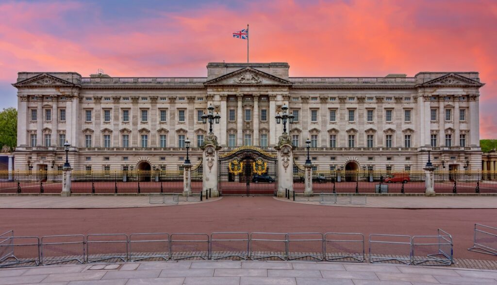 The east front of Buckingham Palace under a pink sky