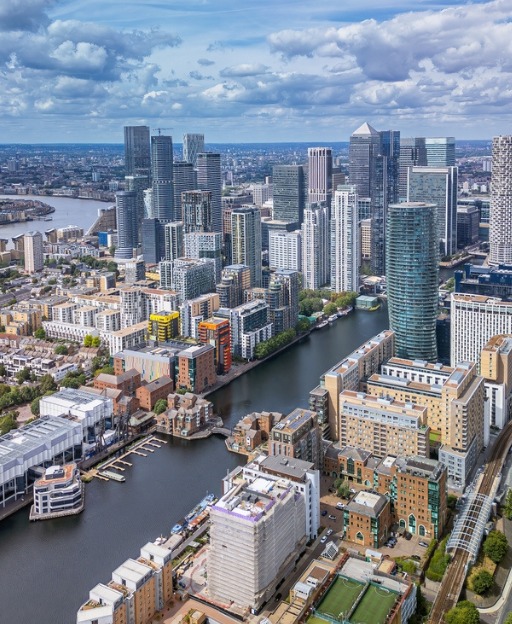 Aerial view of the Canary Wharf skyline and dock water on the Isle of Dogs, London