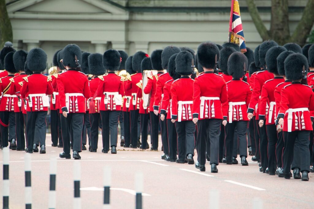Foot Guards in red tunics and bearskins marching