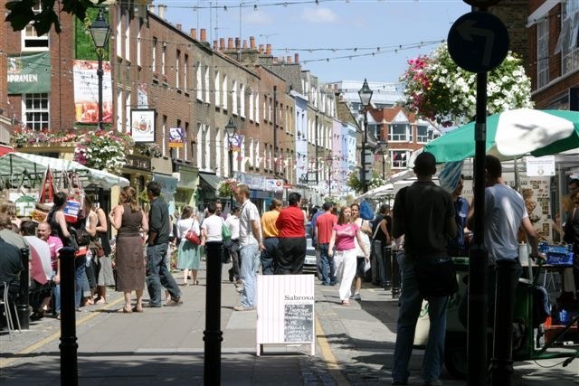 Shoppers and market stalls on Exmouth Market in Clerkenwell.