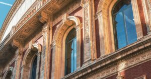 Curved red-brick and terracotta wall of the Royal Albert Hall in South Kensington, London