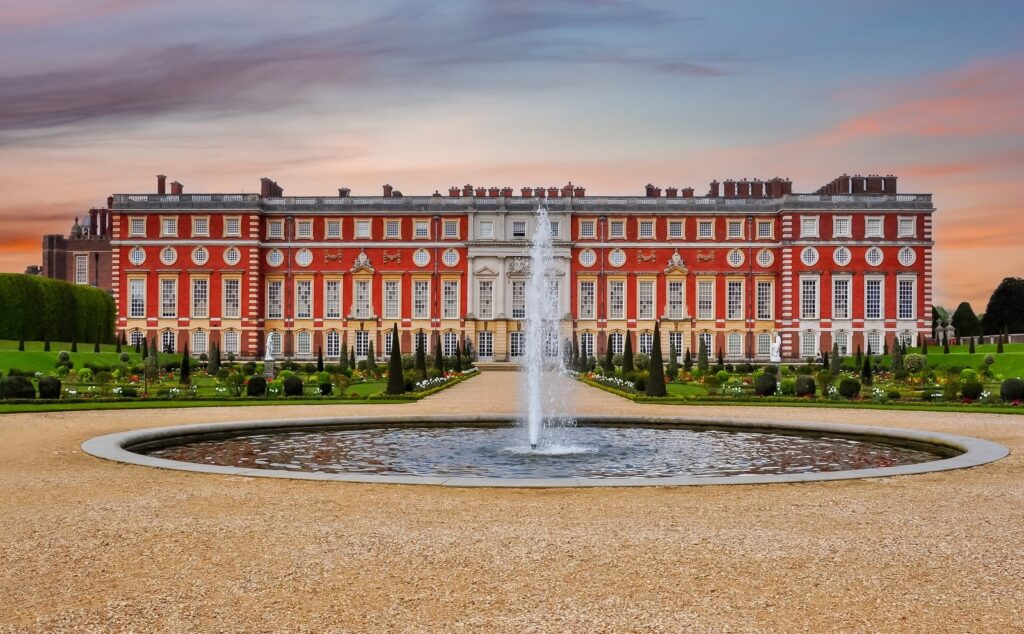 South front of Hampton Court Palace seen across the Privy Garden at sunset