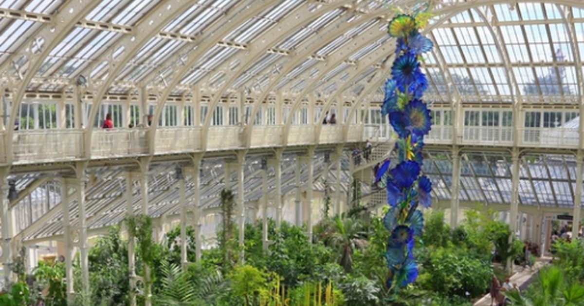 Visitors walk beneath the iron-and-glass roof of the Temperate House at Kew Gardens, London