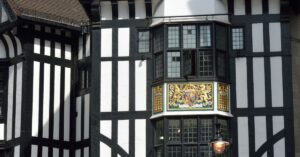 Black-and-white Tudor timber frontage and gilded royal crest on the Liberty London department store