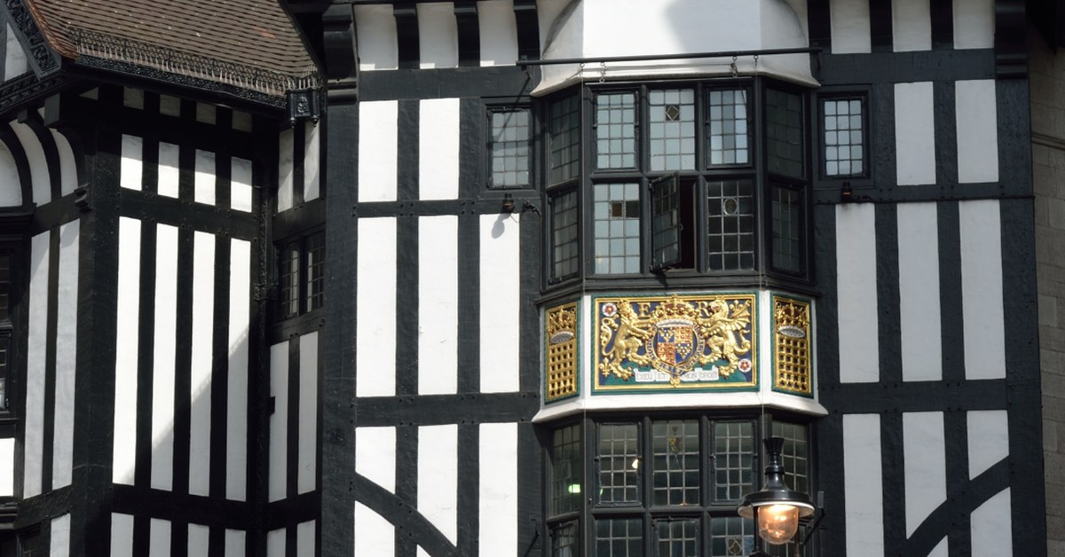 Black-and-white Tudor timber frontage and gilded royal crest on the Liberty London department store