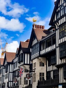 Black-and-white Tudor-revival timber frontage of the Liberty London department store with a Union Jack