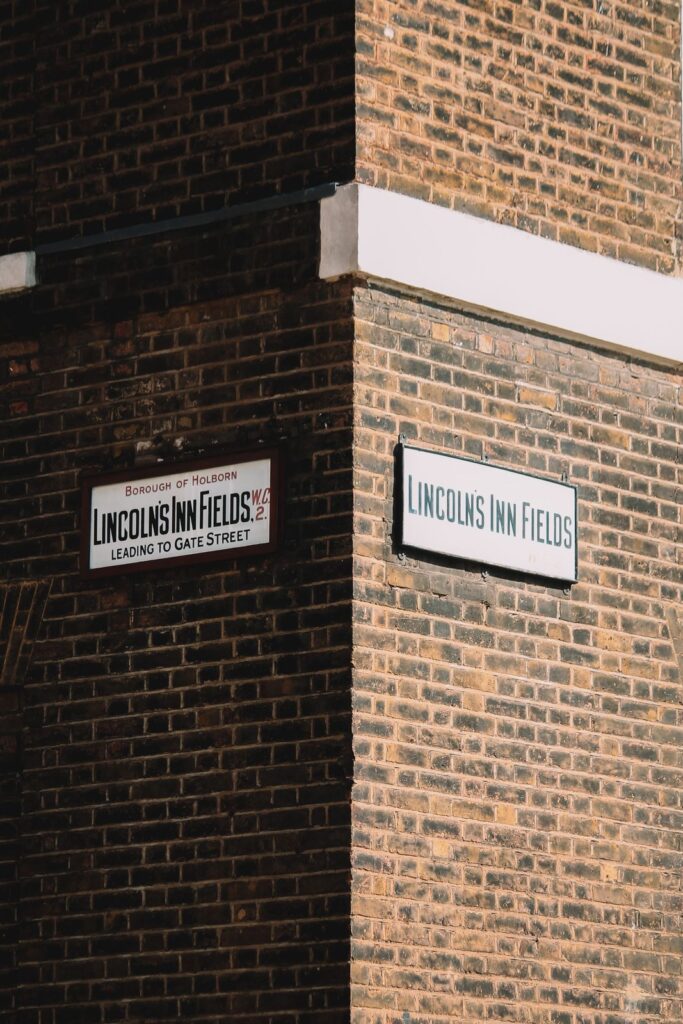 Lincoln's Inn Fields street signs on a brick corner
