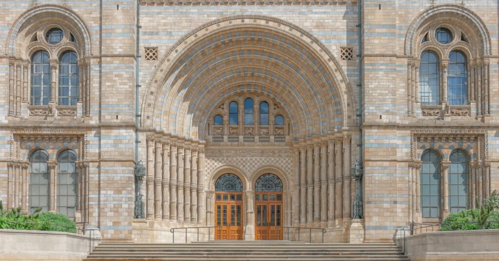 Arched entrance and terracotta facade of the Natural History Museum in South Kensington, London