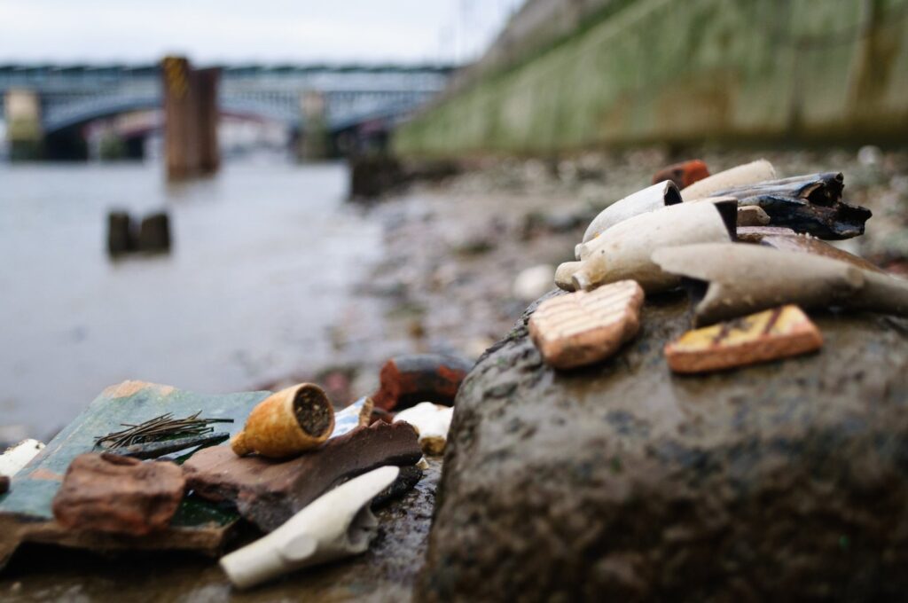 Old clay pipe stems and pottery found mudlarking on the Thames foreshore at low tide