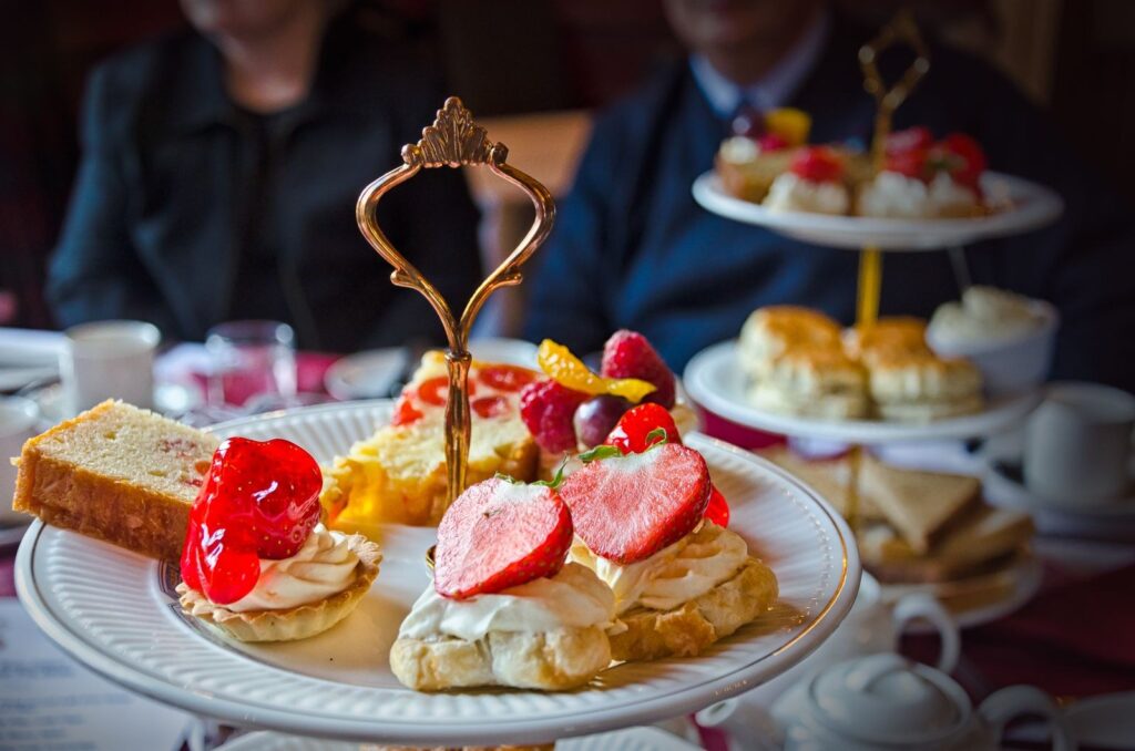 Scones and small cakes on a tiered stand at afternoon tea