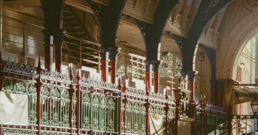 Victorian cast-iron arches and painted railings at Smithfield Market, London