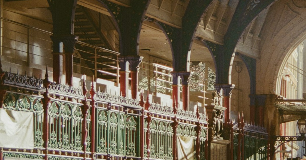 Victorian cast-iron arches and green and red painted railings at Smithfield Market, London