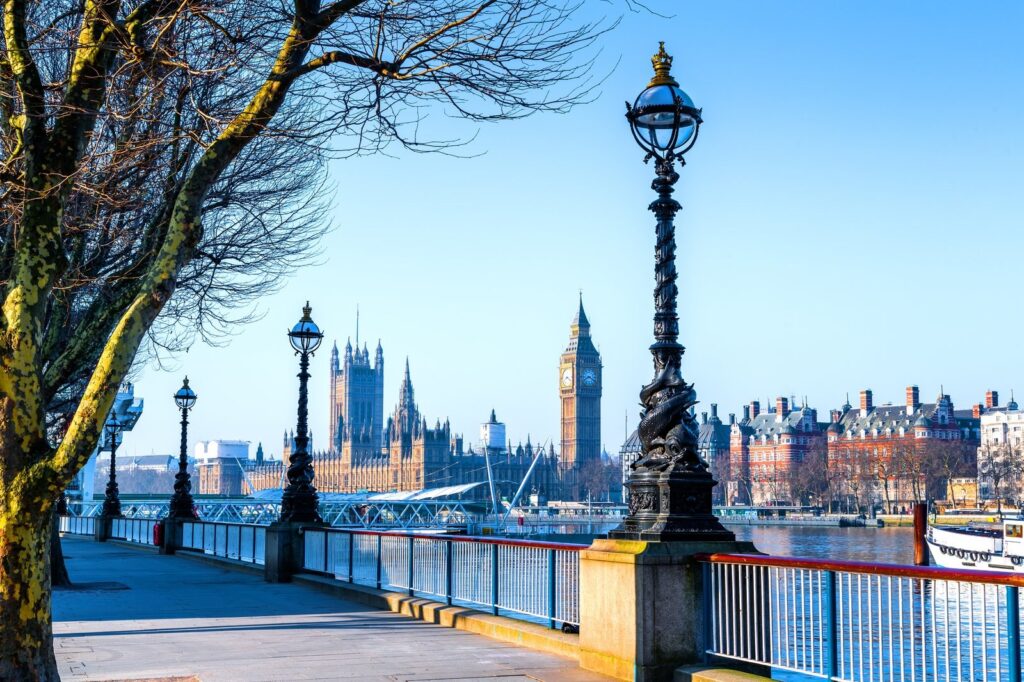 South Bank riverside walk with a lamp post and the Palace of Westminster across the Thames