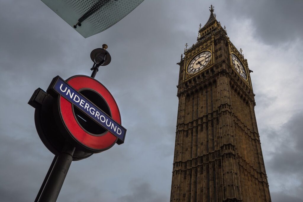 A London Underground sign beside Big Ben at Westminster