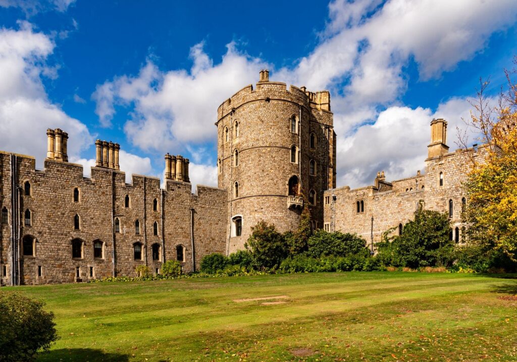 Towers and walls of Windsor Castle under a blue sky